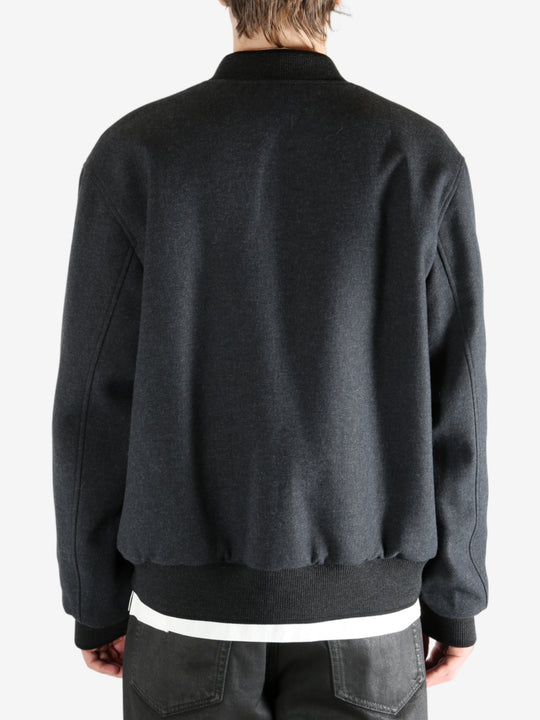 Gray jacket worn by a person, showing the jacket's fit