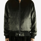 Green bomber jacket worn by a person,showing the jacket fit