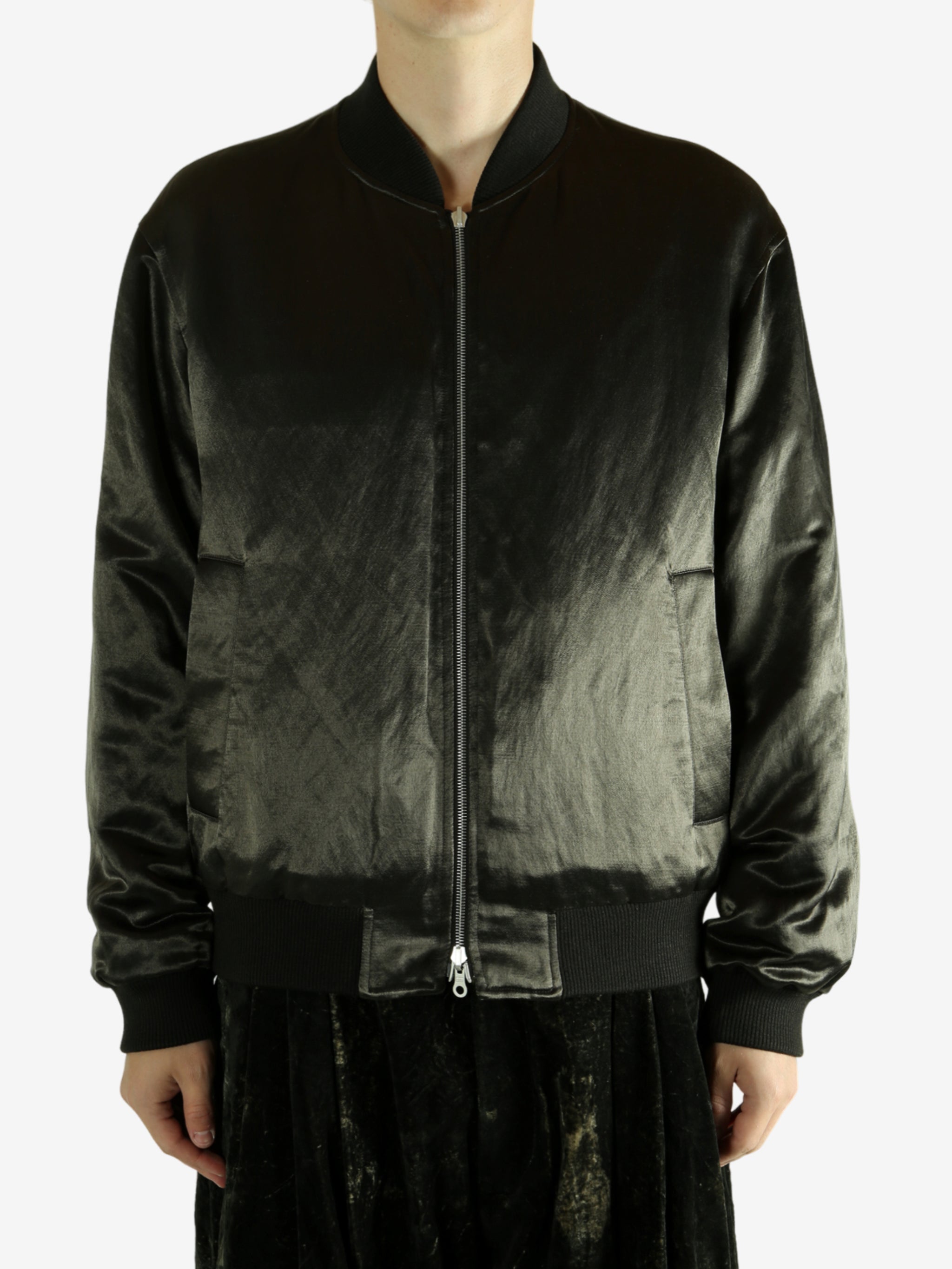 Green bomber jacket worn by a person,showing the jacket fit