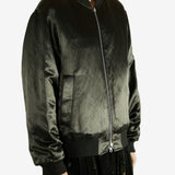 Green bomber jacket worn by a person,showing the jacket fit