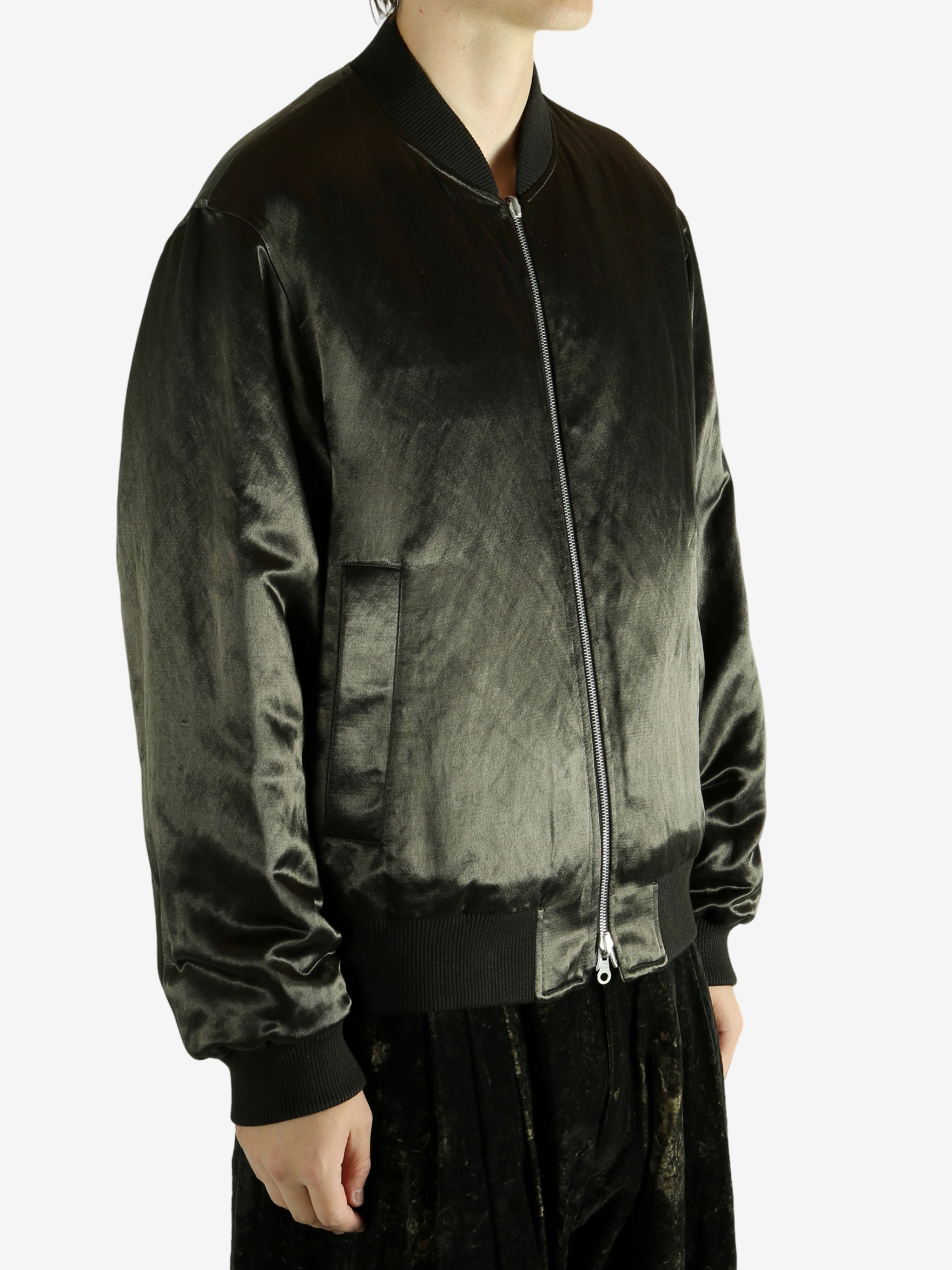 Green bomber jacket worn by a person,showing the jacket fit