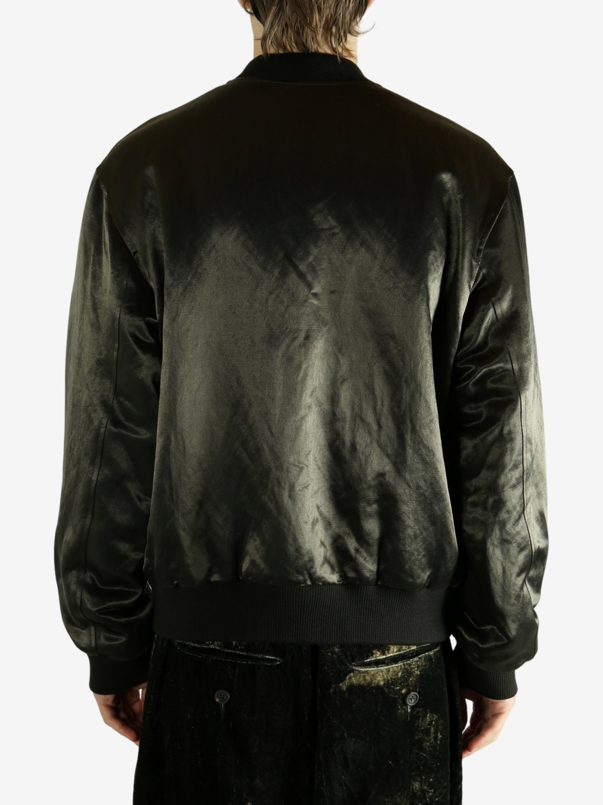Green bomber jacket worn by a person,showing the jacket fit