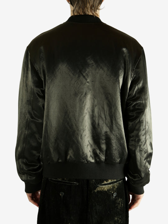 Green bomber jacket worn by a person,showing the jacket fit