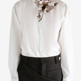 White shirt worn by a person, showing the shirt's fit