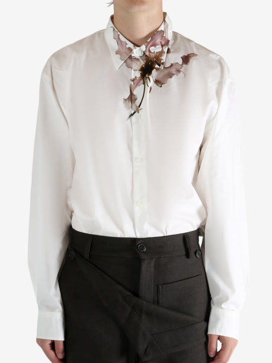 White shirt worn by a person, showing the shirt's fit