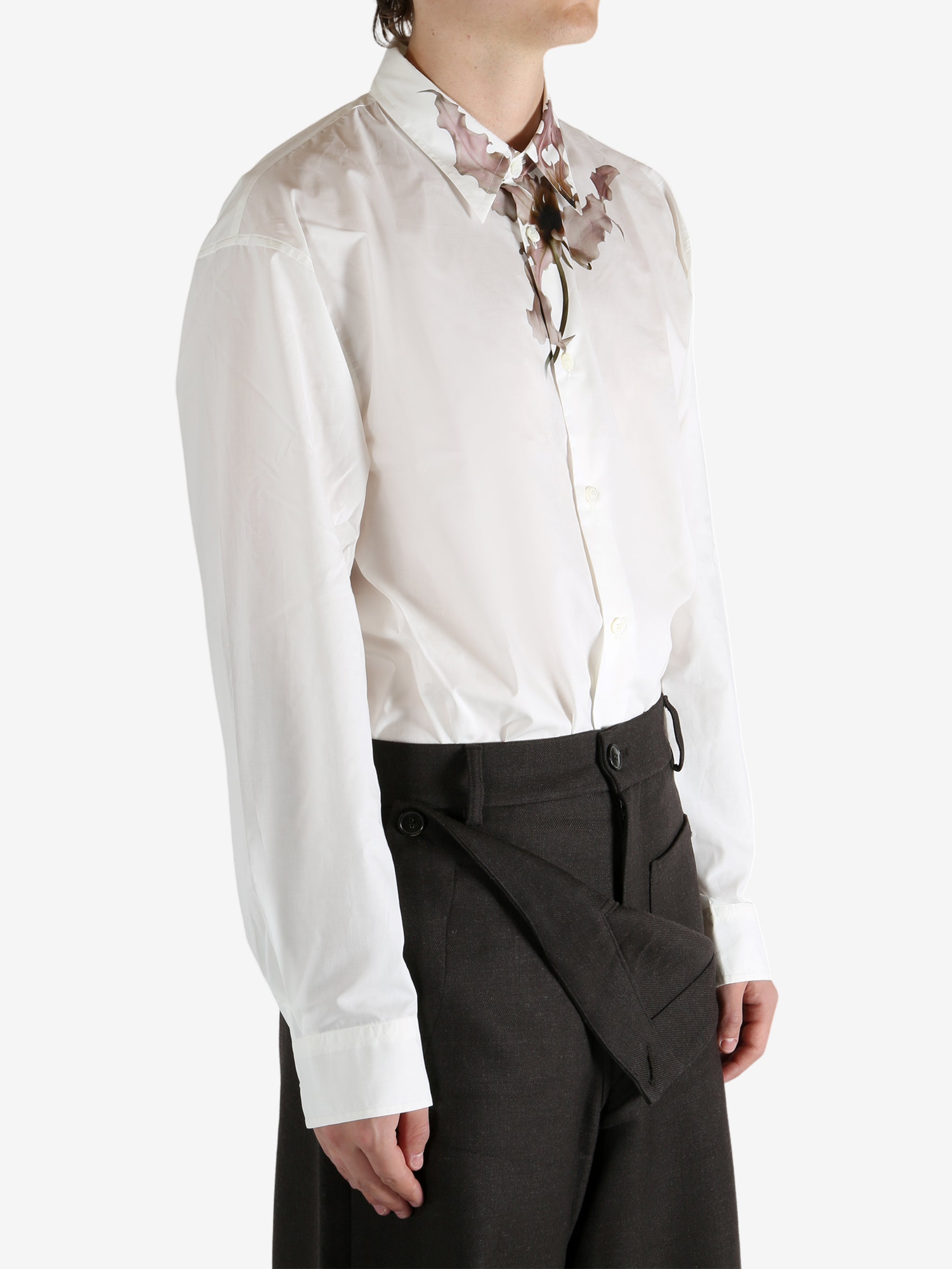 White shirt worn by a person, showing the shirt's fit