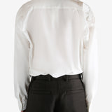 White shirt worn by a person, showing the shirt's fit