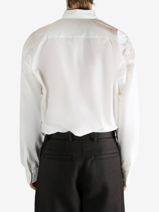White shirt worn by a person, showing the shirt's fit