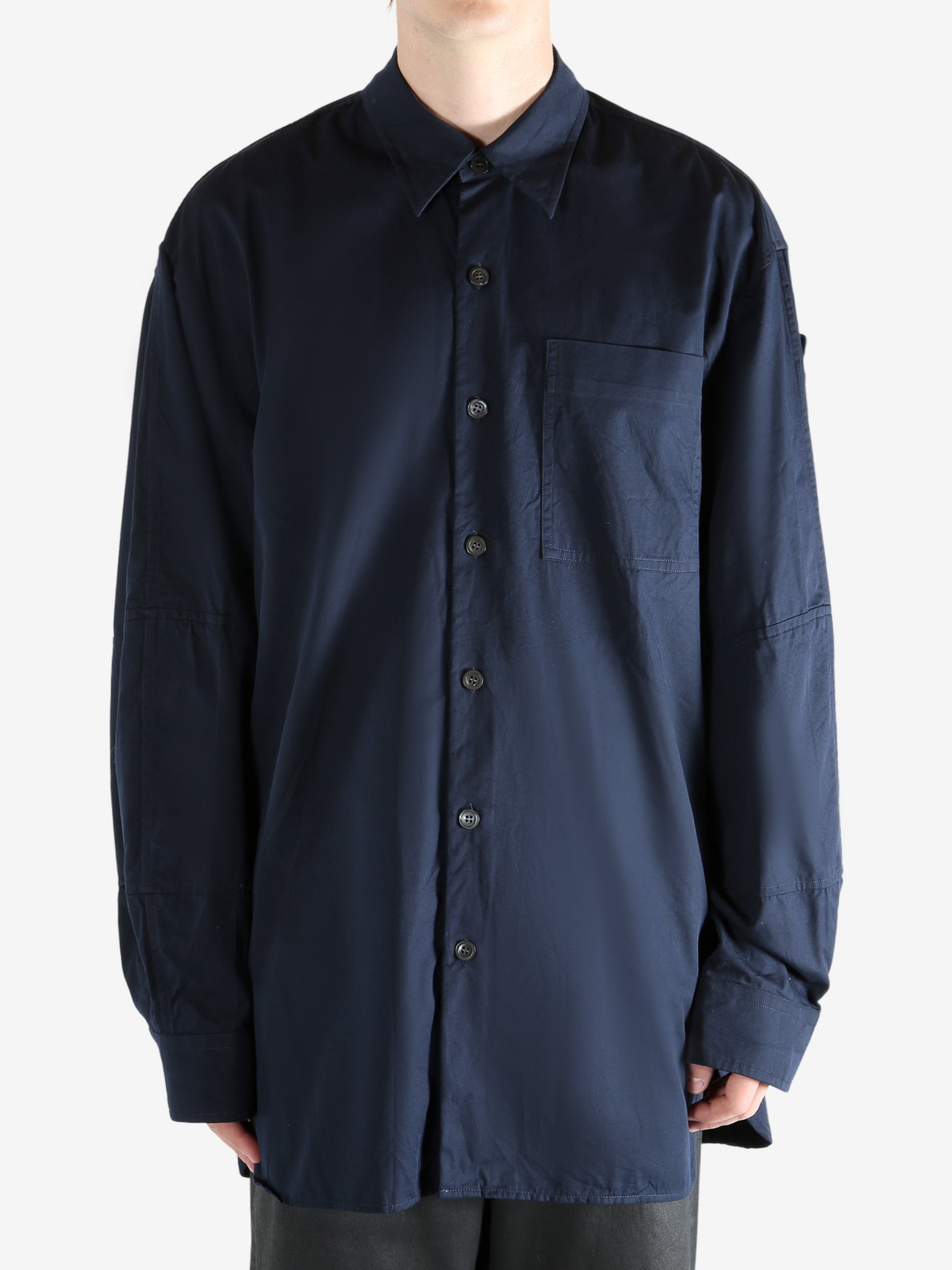 Navy shirt worn by a person, showing the shirt's fit