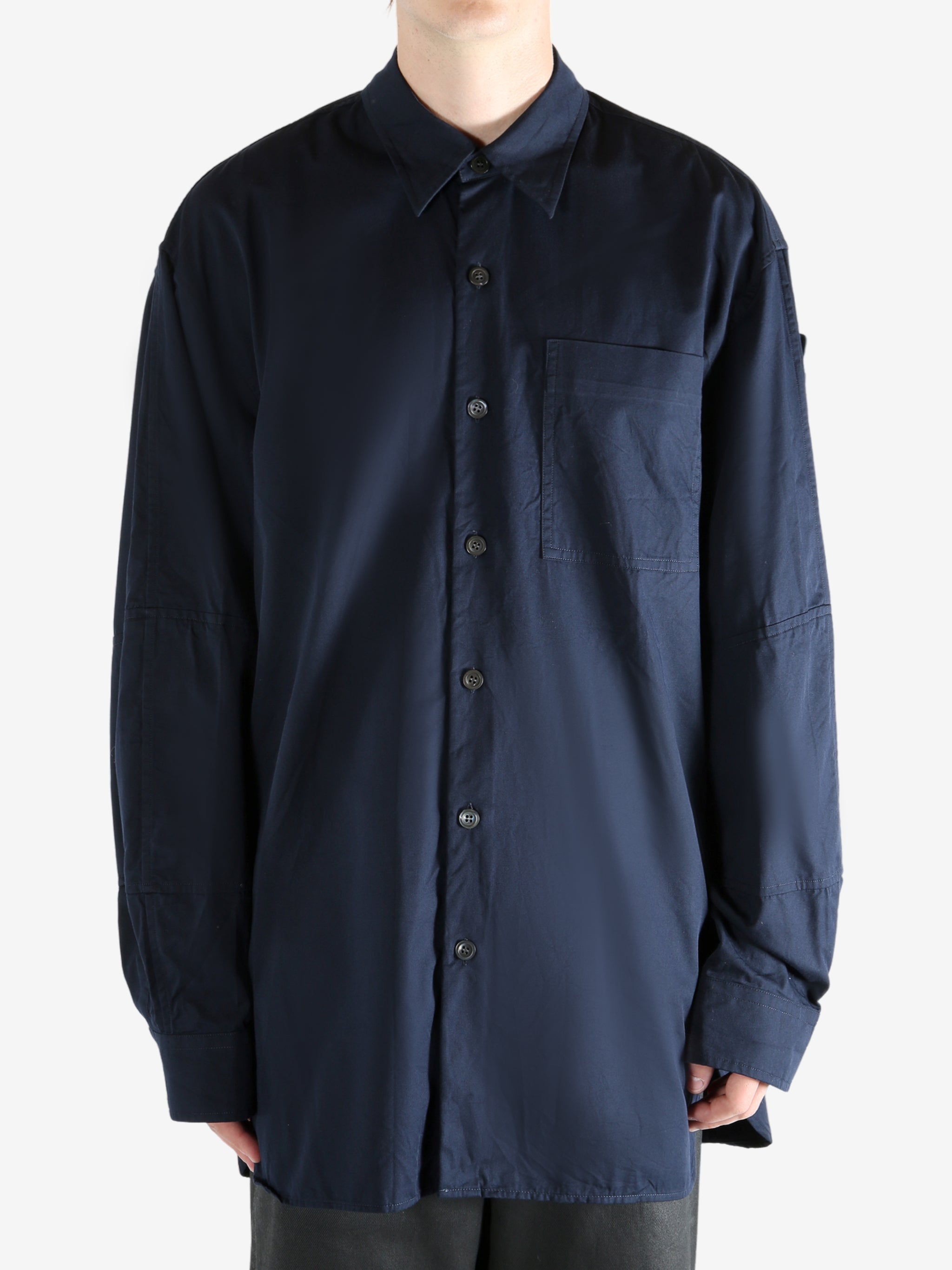 Navy shirt worn by a person, showing the shirt's fit