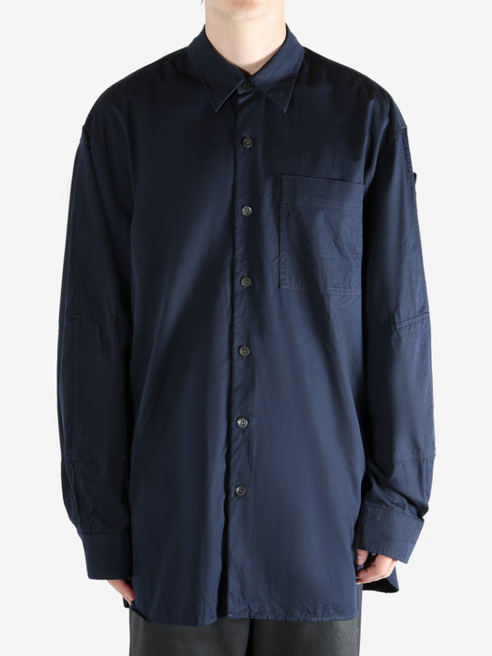 Navy shirt worn by a person, showing the shirt's fit