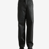 Black pants worn by a person, showing the pants' fit