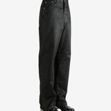 Black pants worn by a person, showing the pants' fit