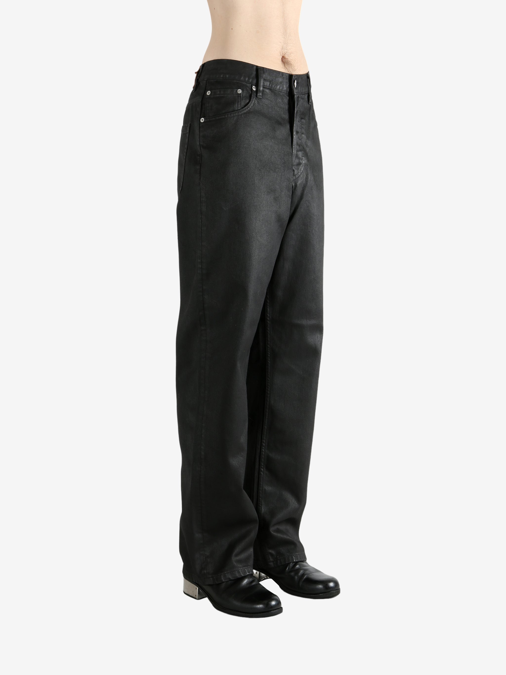 Black pants worn by a person, showing the pants' fit
