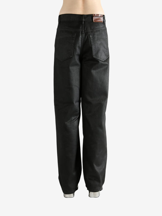 Black pants worn by a person, showing the pants' fit
