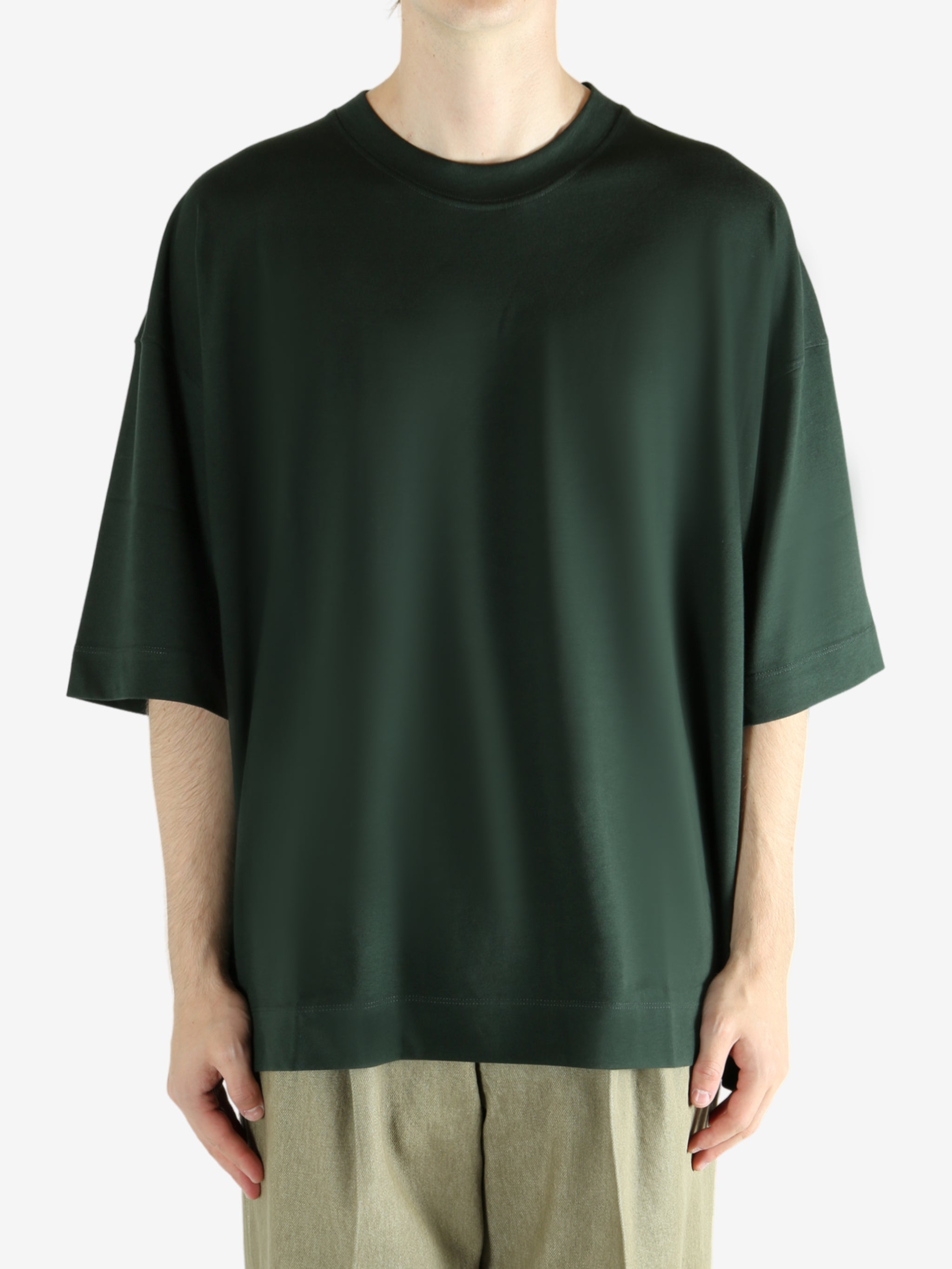 Green shirts worn by a person, showing the shirts fit