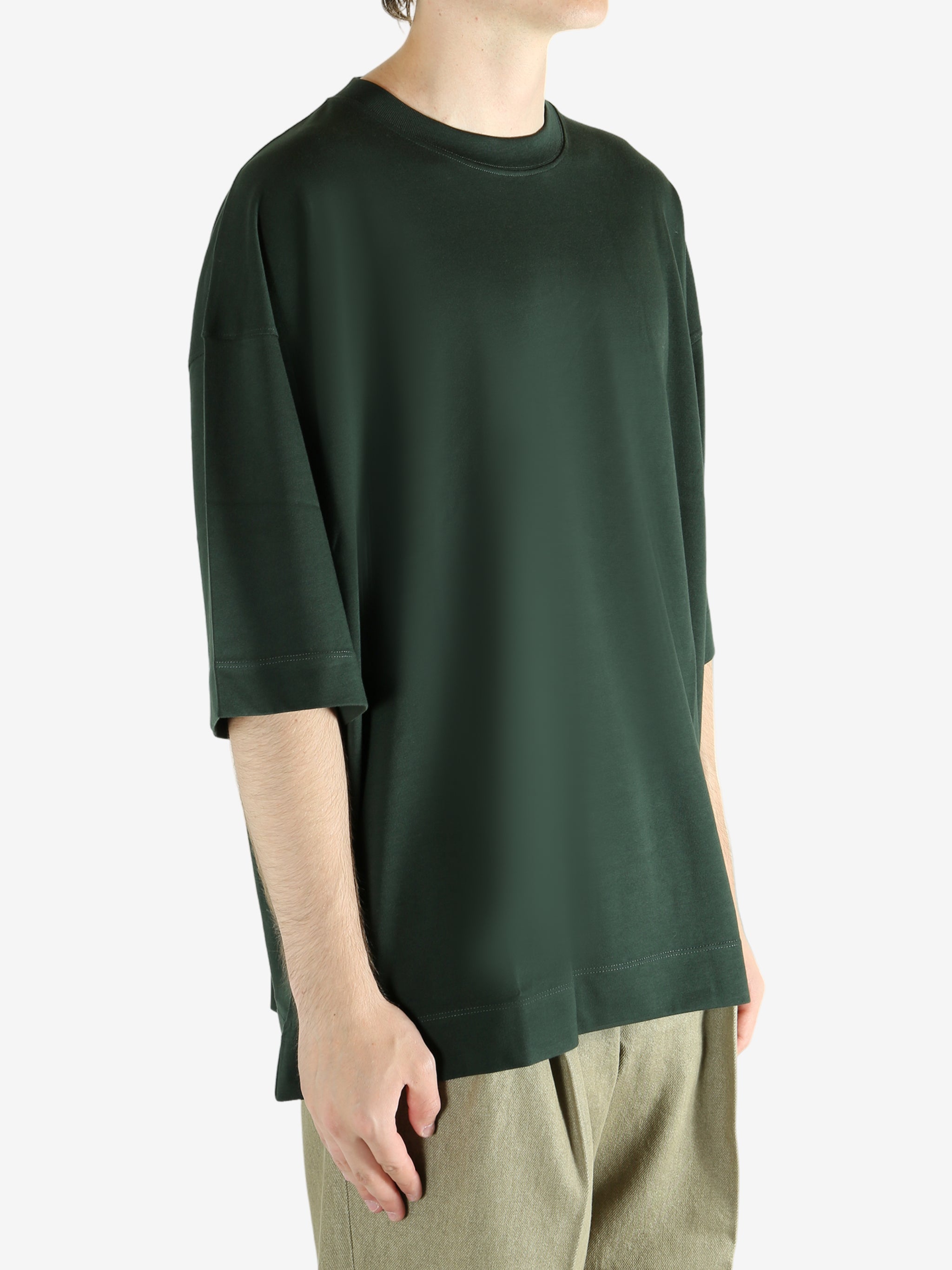 Green shirts worn by a person, showing the shirts fit
