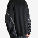 Black sweater worn by a person, showing the sweater's fit