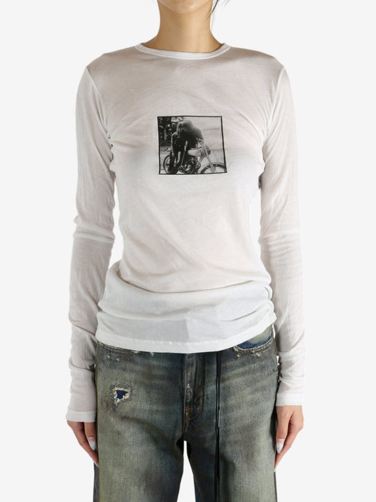 White t-shirt worn by a person, showing the shirt's fit