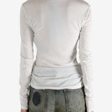 White t-shirt worn by a person, showing the shirt's fit