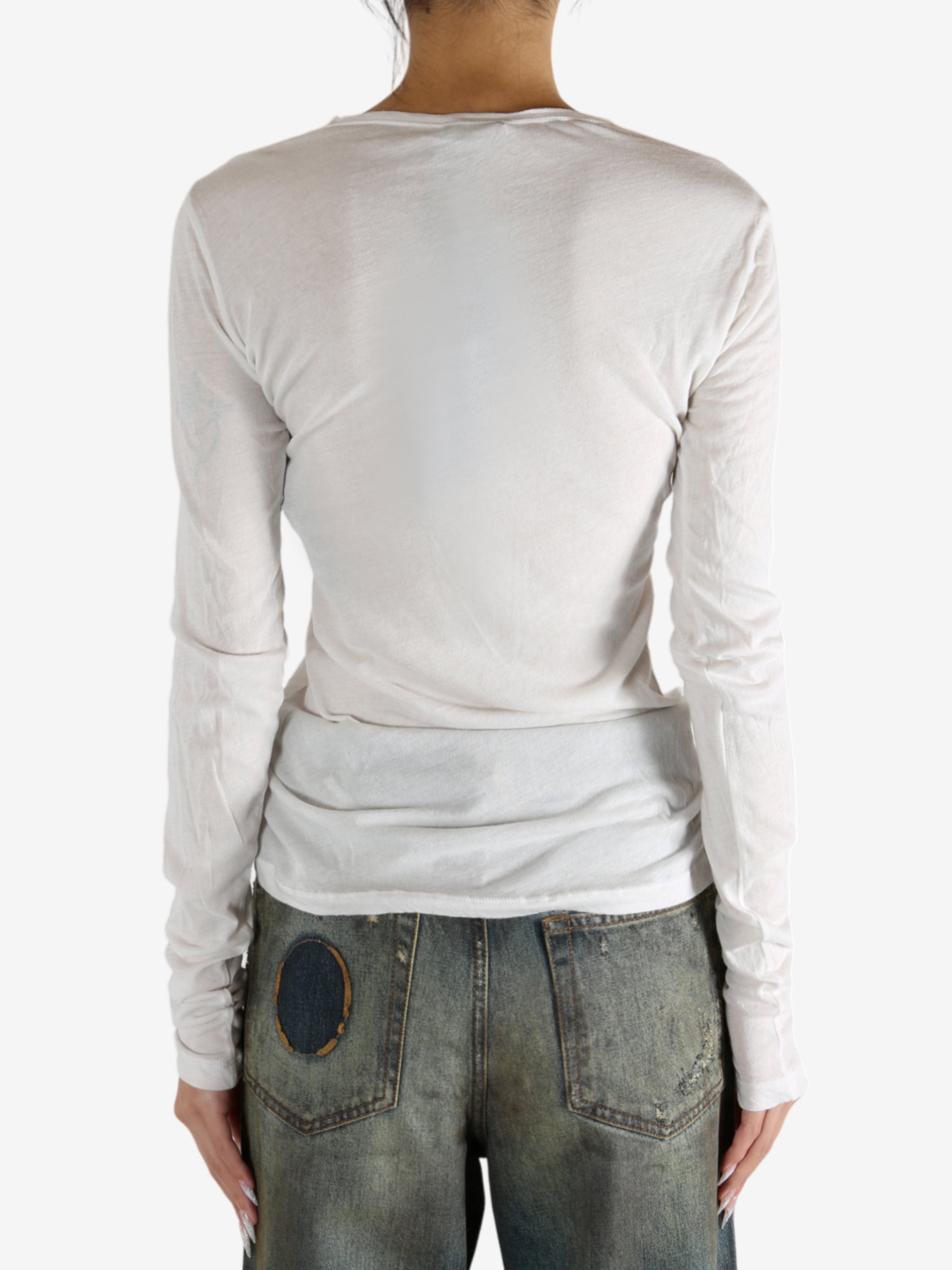 White t-shirt worn by a person, showing the shirt's fit