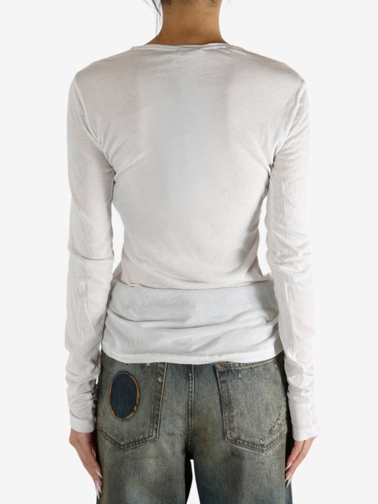 White t-shirt worn by a person, showing the shirt's fit