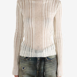 White sweater worn by a person,showing the sweater's fit