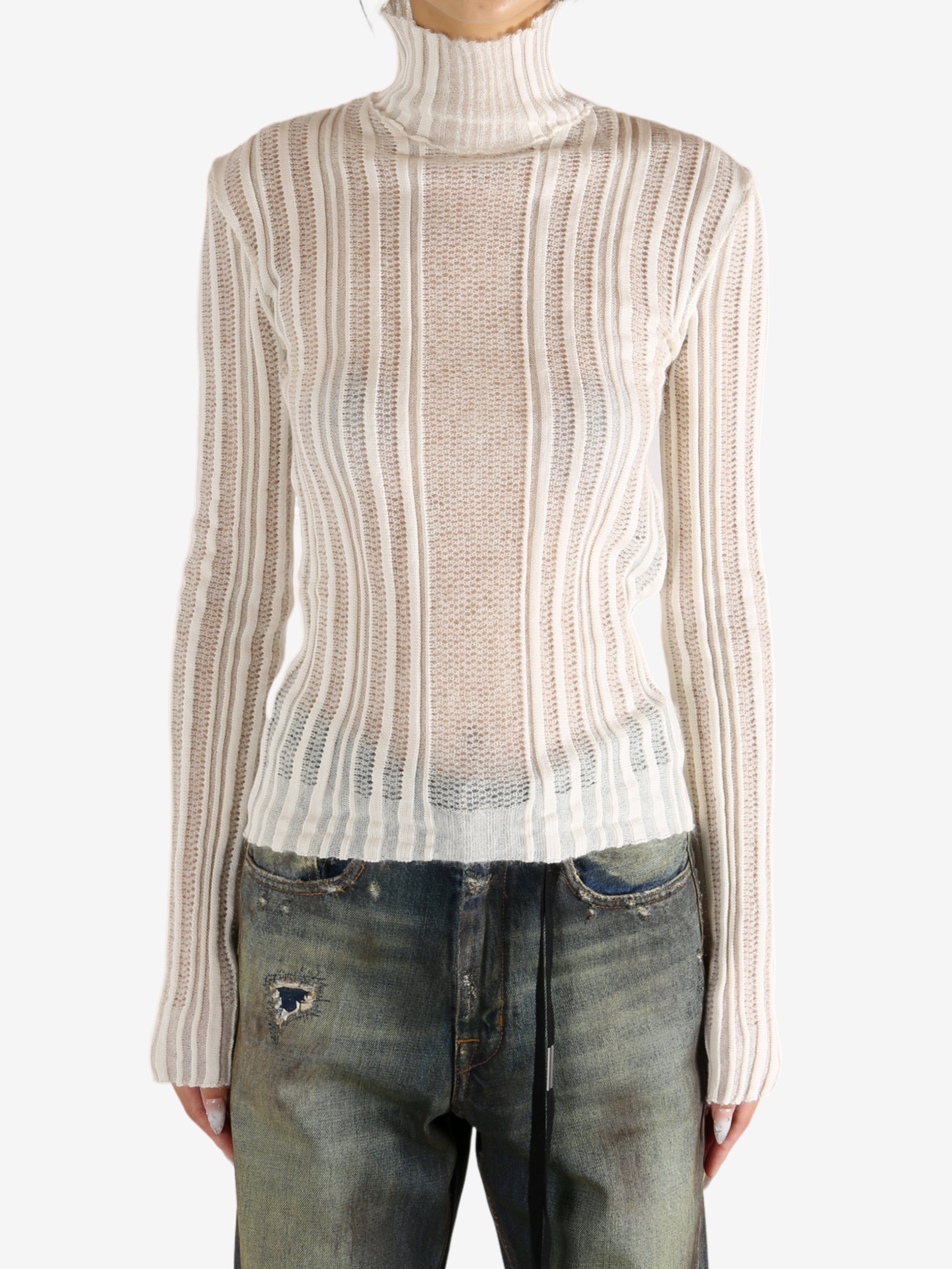 White sweater worn by a person,showing the sweater's fit