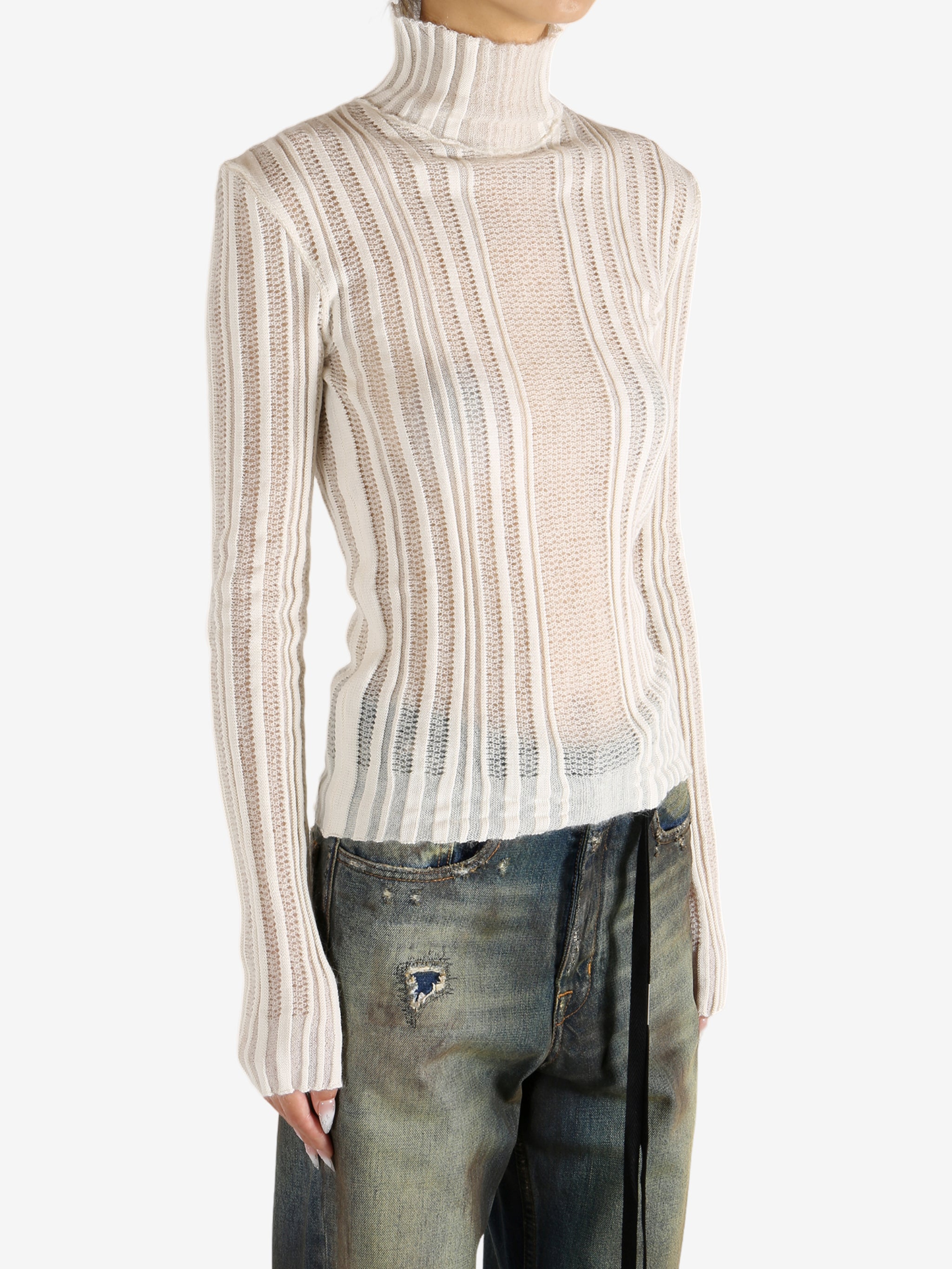 White sweater worn by a person,showing the sweater's fit