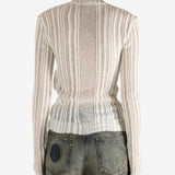 White sweater worn by a person,showing the sweater's fit