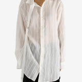 White shirt worn by a person, showing the shirt's fit