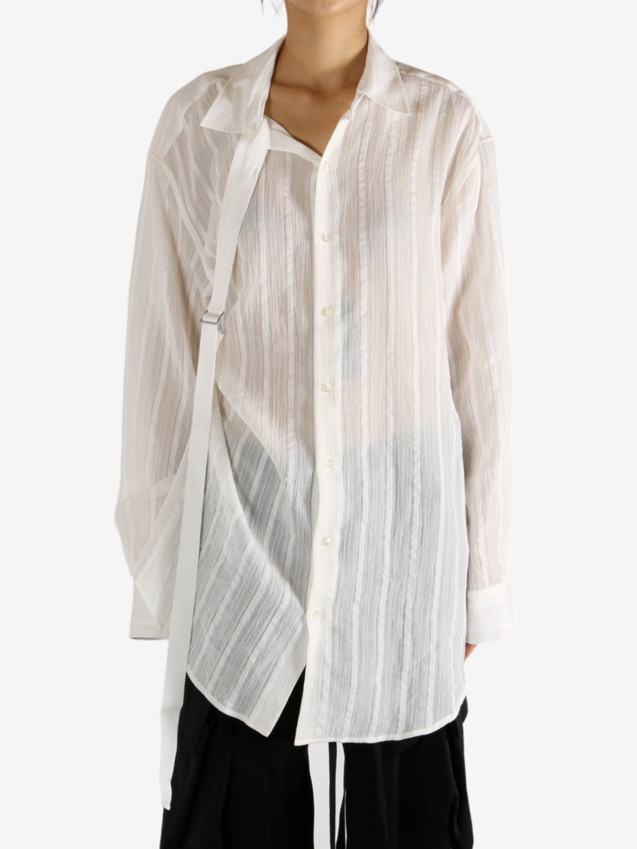White shirt worn by a person, showing the shirt's fit