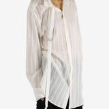 White shirt worn by a person, showing the shirt's fit