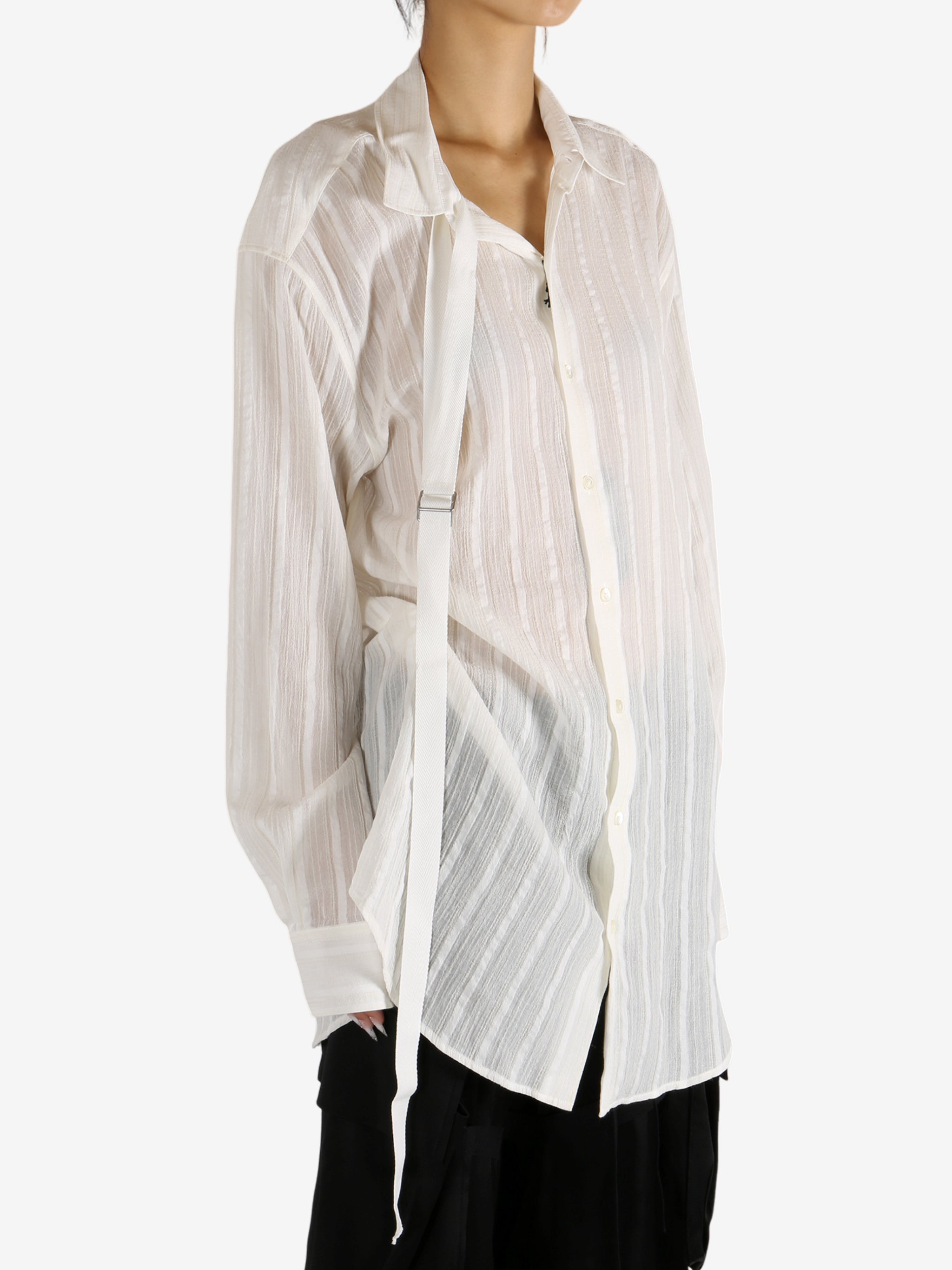 White shirt worn by a person, showing the shirt's fit