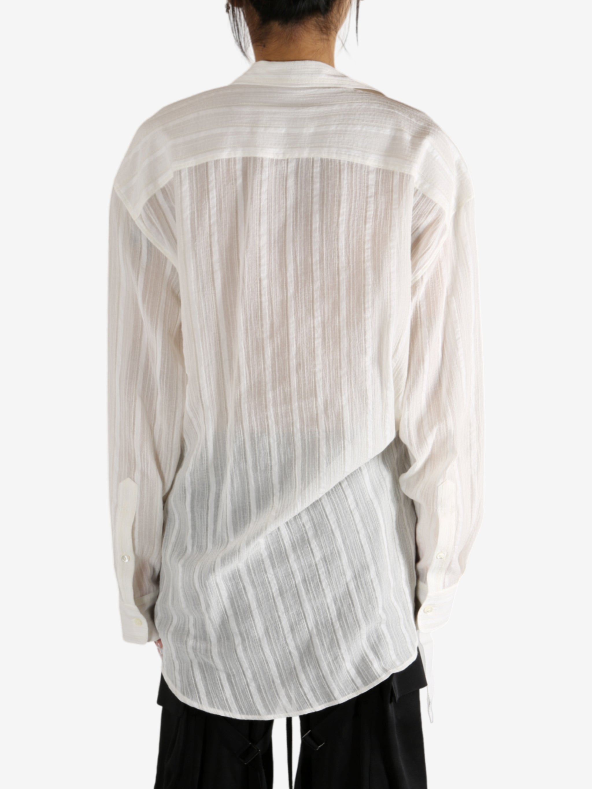 White shirt worn by a person, showing the shirt's fit