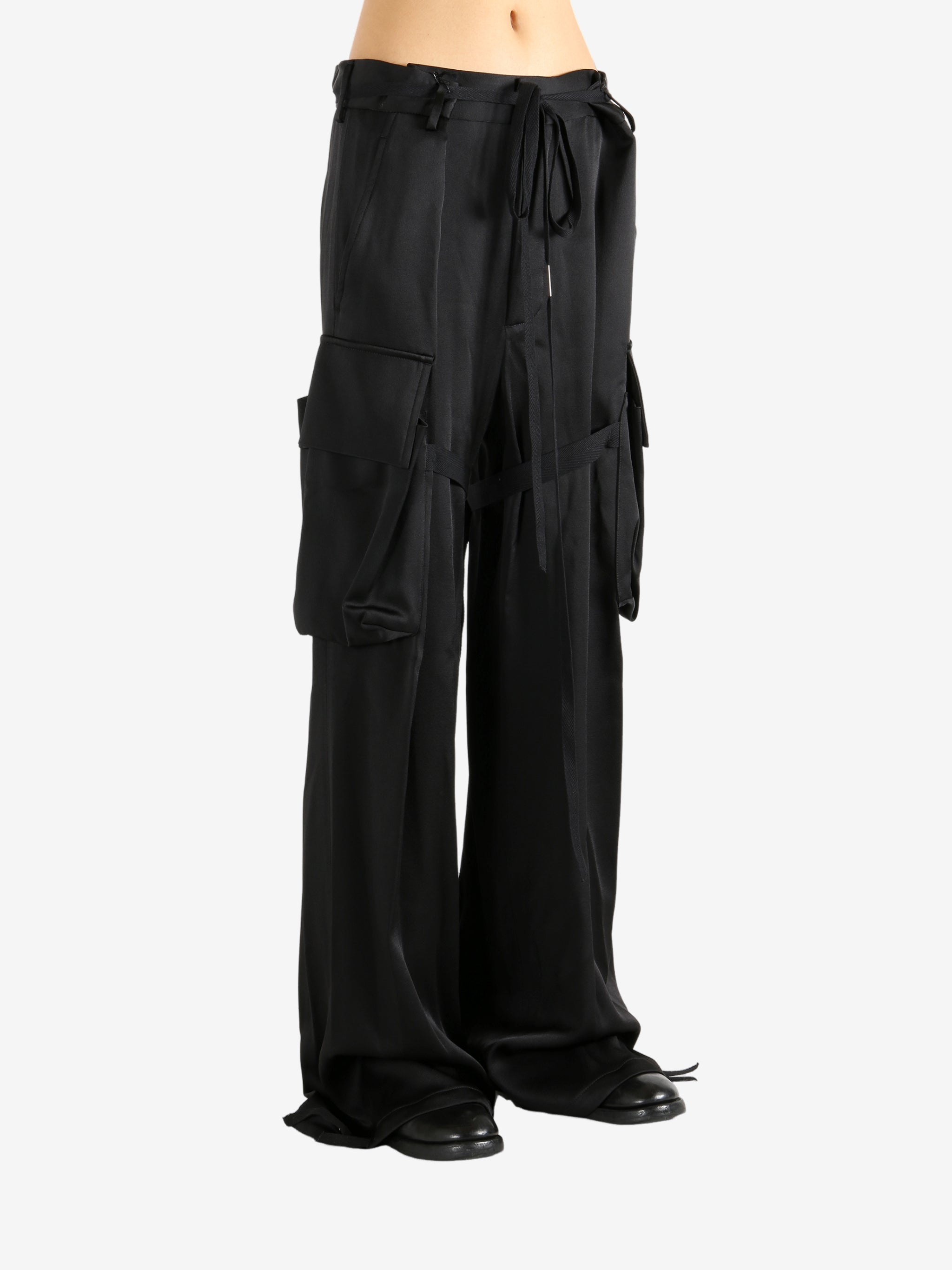 Black pants worn by a person, showing the pants' fit