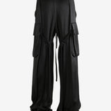 Black pants worn by a person, showing the pants' fit