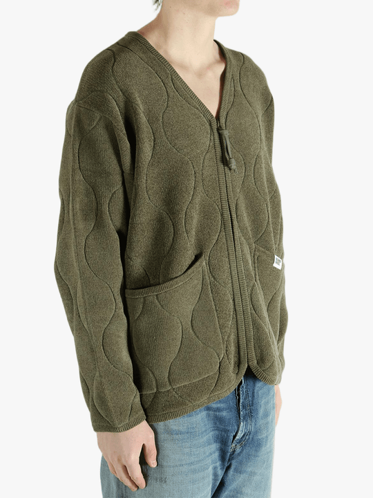 Green jacket worn by a person, showing the jacket fit