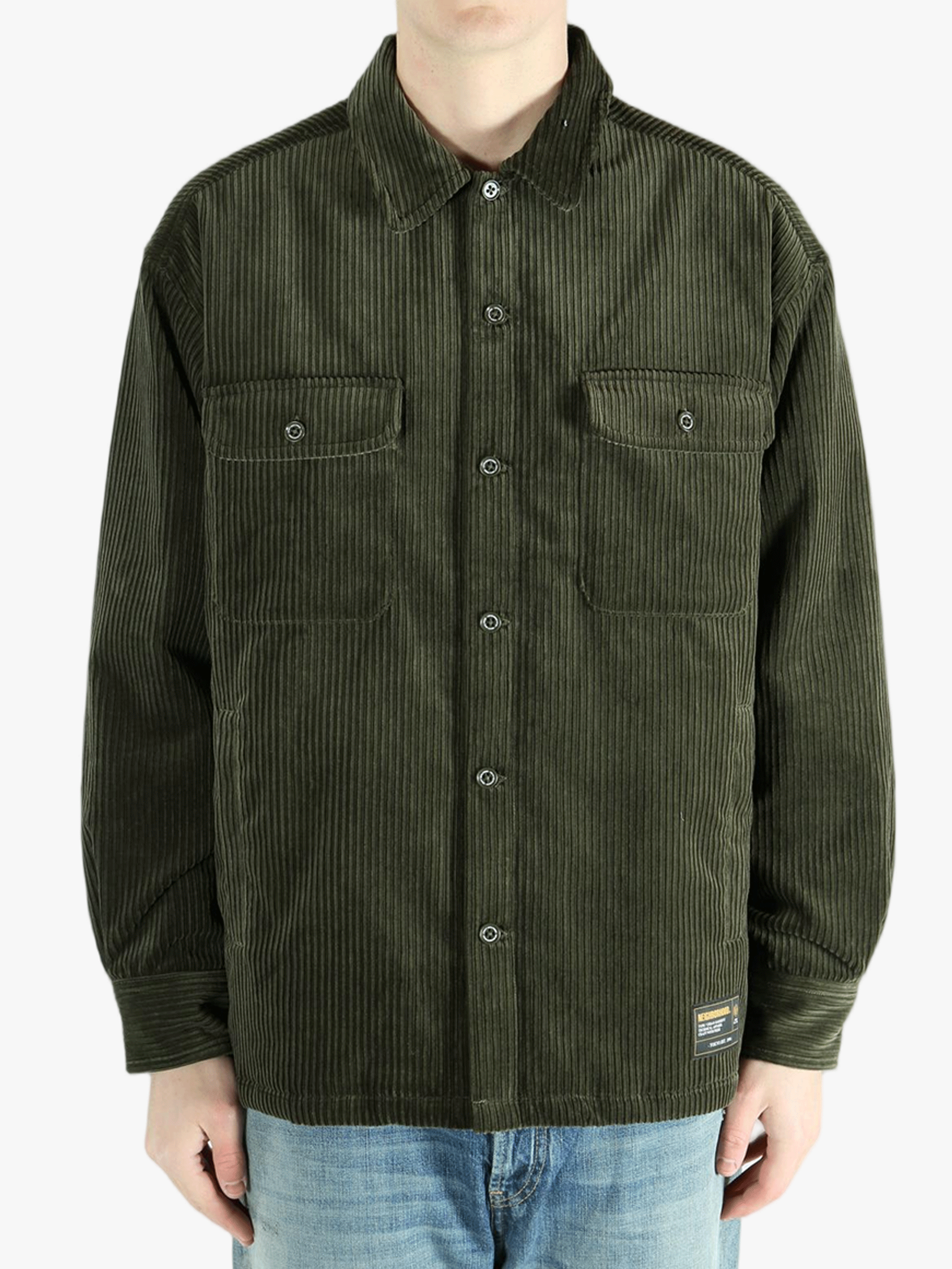 Green shirt worn by a person, showing the shirt's fit