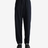 Navy pants worn by a person, showing the pant's fit