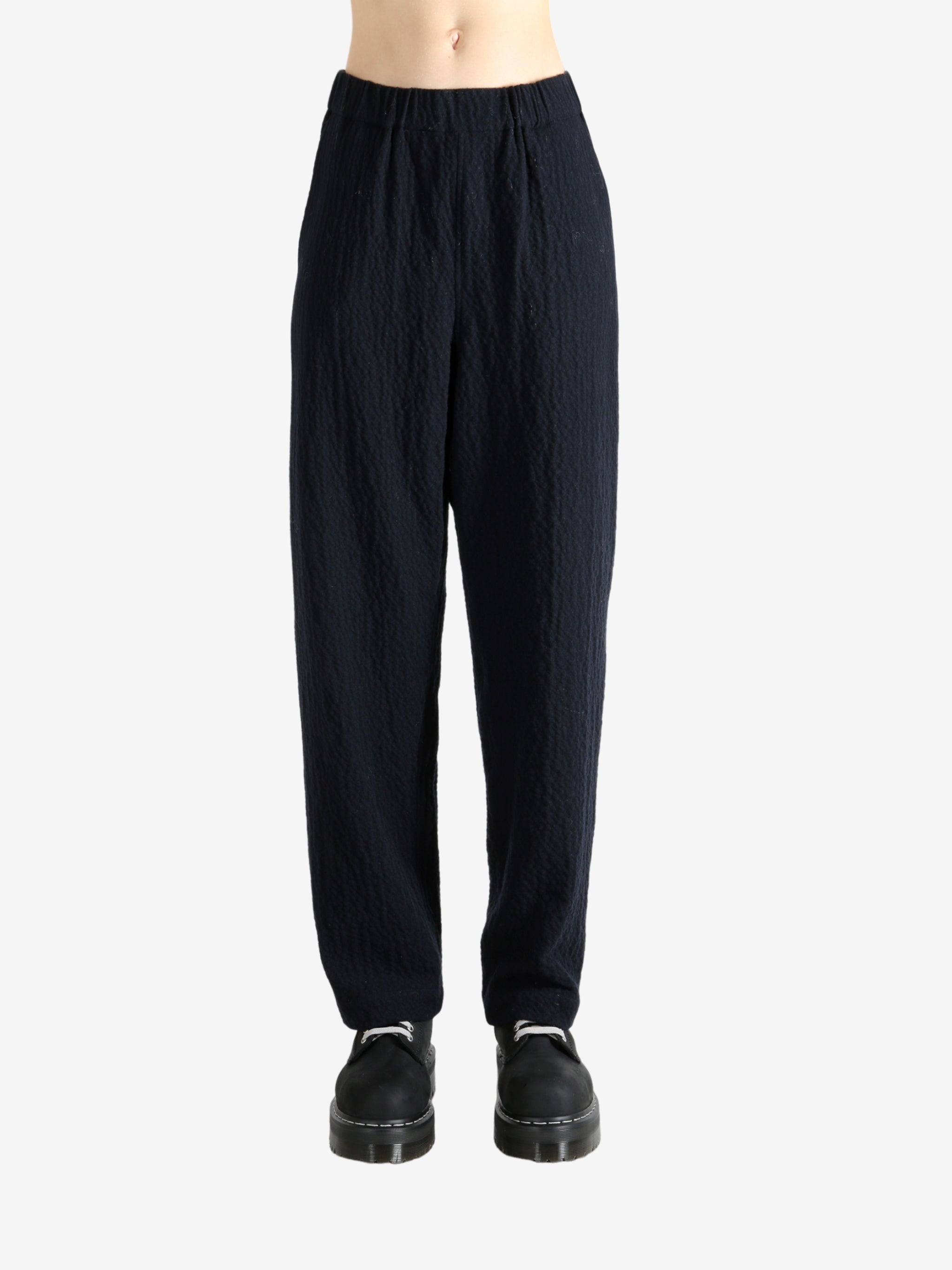 Navy pants worn by a person, showing the pant's fit