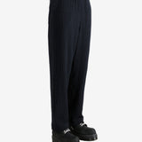 Navy pants worn by a person, showing the pant's fit