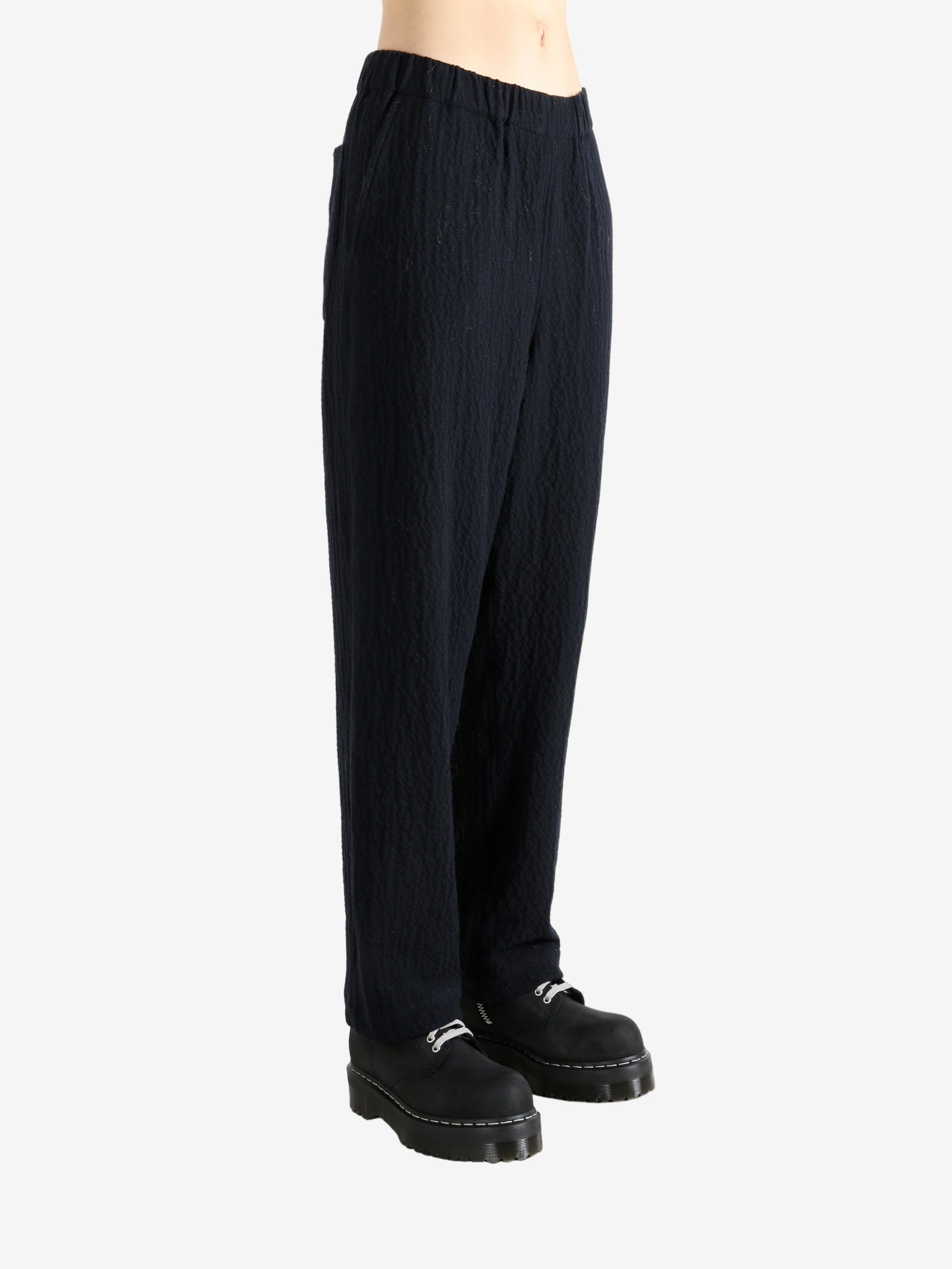 Navy pants worn by a person, showing the pant's fit