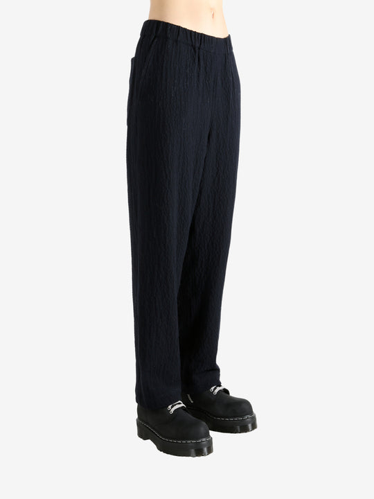 Navy pants worn by a person, showing the pant's fit