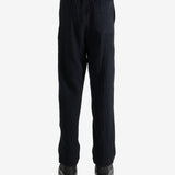 Navy pants worn by a person, showing the pant's fit