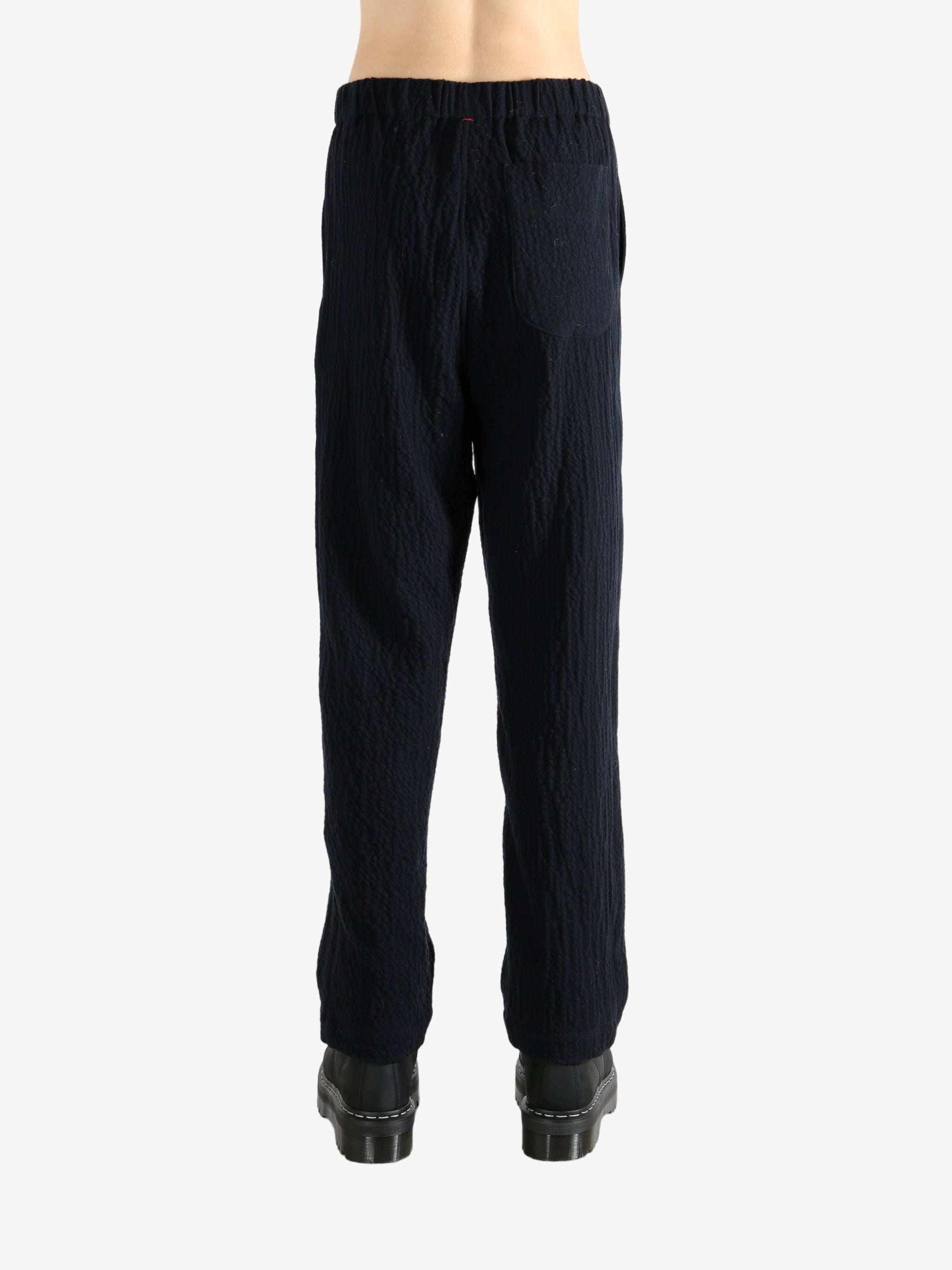Navy pants worn by a person, showing the pant's fit