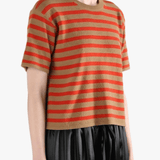 Brown t-shirt worn by a person, side view