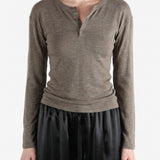 Grey knitwear worn by a person, showing the knitwear fit