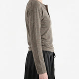 Grey knitwear worn by a person, side view