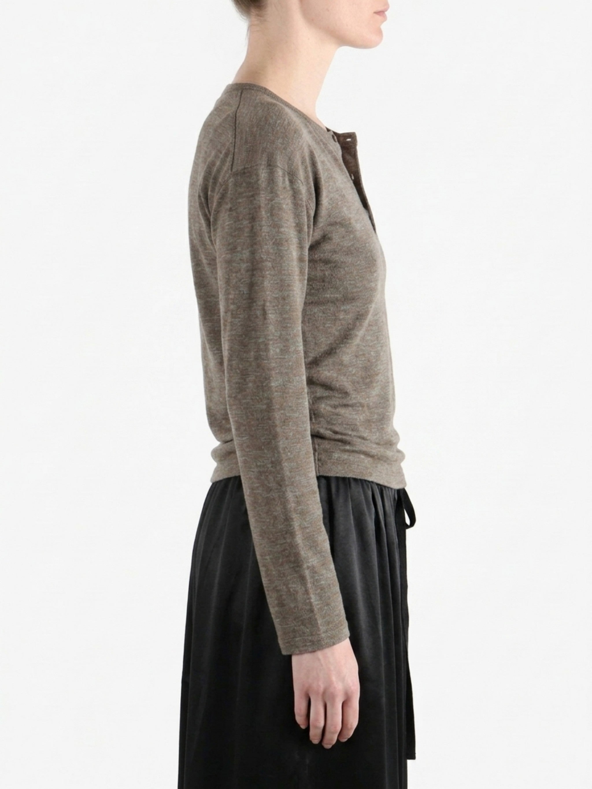 Grey knitwear worn by a person, side view
